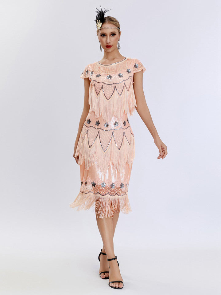 This 1920s Charleston Sequins Tassel Patchwork Dress wraps her in 1920s elegance, one twirl at a time