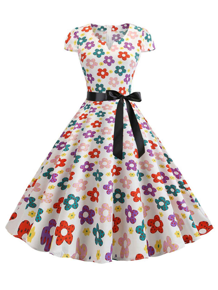 She slips into this 1950s Cap Sleeve Polka Dot Belted Dress and suddenly it&