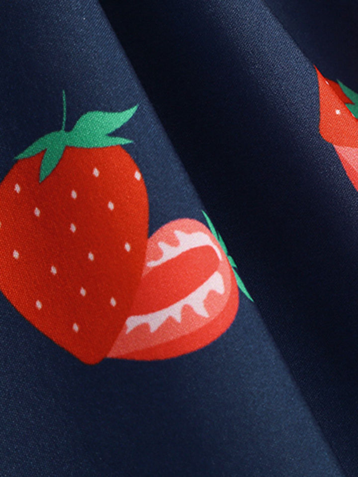 This 1950s Daisy &amp; Strawberry Print Sleeveless Dress wraps her in 1950s elegance, one twirl at a time