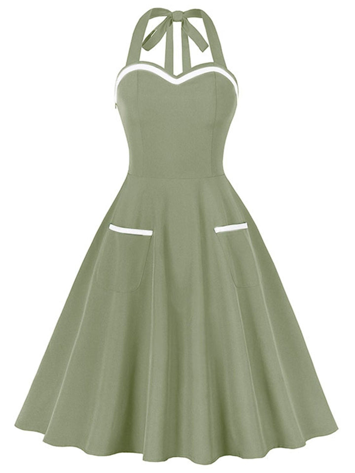 She slips into this 1950s Halter Pockets Backless Swing Dress and suddenly it&