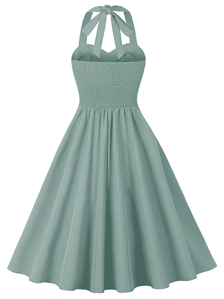 She slips into this 1950s Halter Pockets Backless Swing Dress and suddenly it&