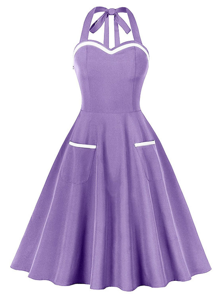 This 1950s Halter Pockets Backless Swing Dress wraps her in 1950s elegance, one twirl at a time