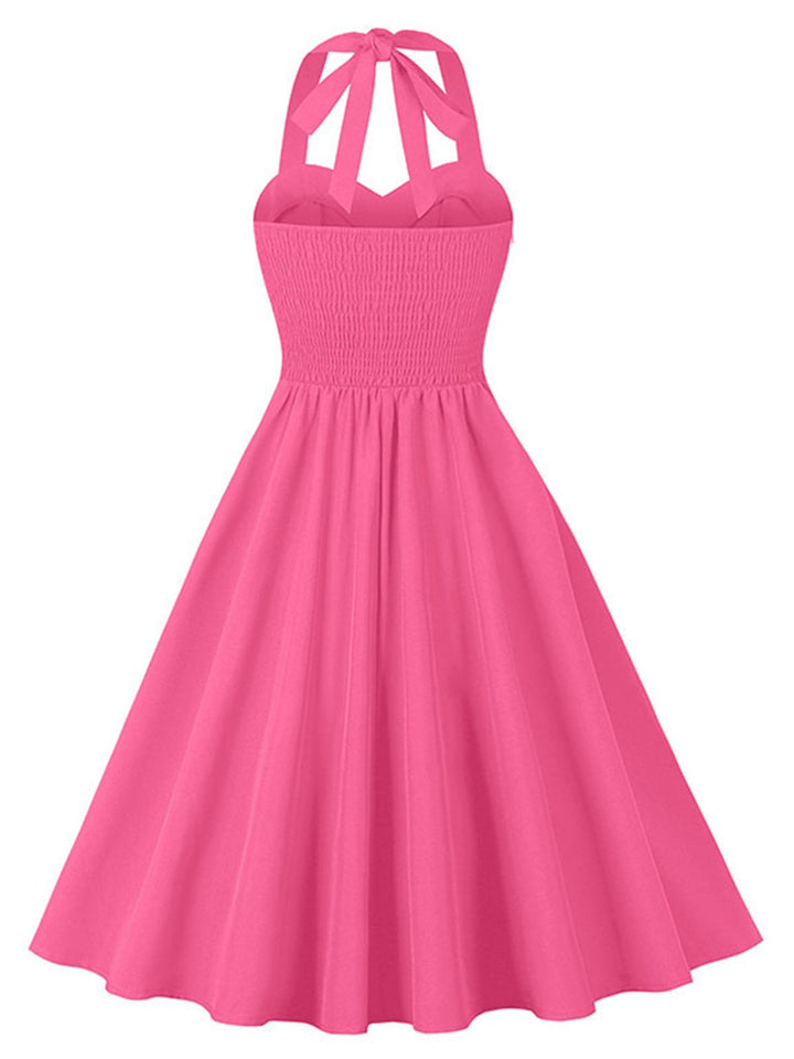This 1950s Halter Pockets Backless Swing Dress wraps her in 1950s elegance, one twirl at a time