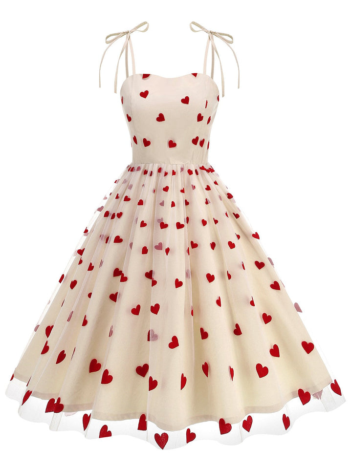 She slips into this 1950s Heart Mesh Patchwork Suspender Dress and suddenly it&