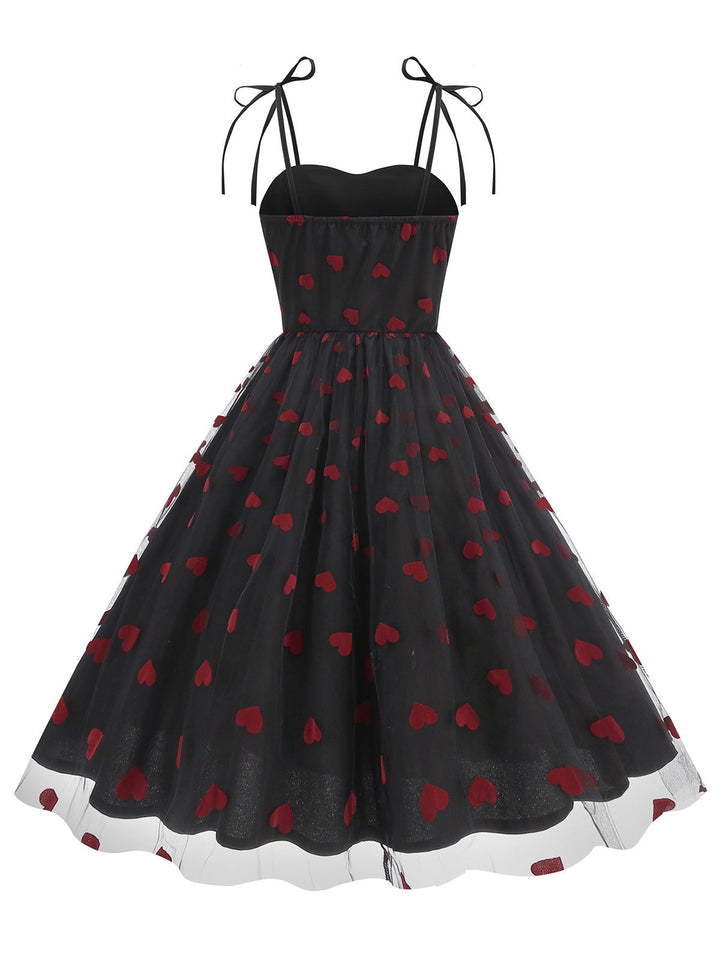 She slips into this 1950s Heart Mesh Patchwork Suspender Dress and suddenly it&