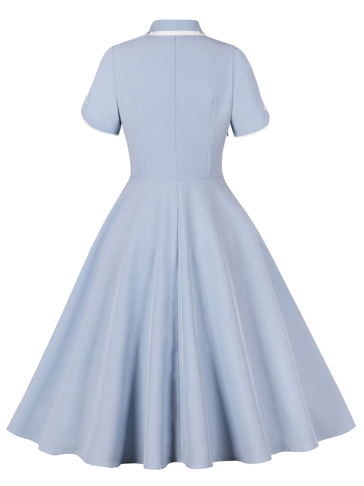 She slips into this 1950s Lapel Buttoned Short Sleeve Solid Dress and suddenly it&