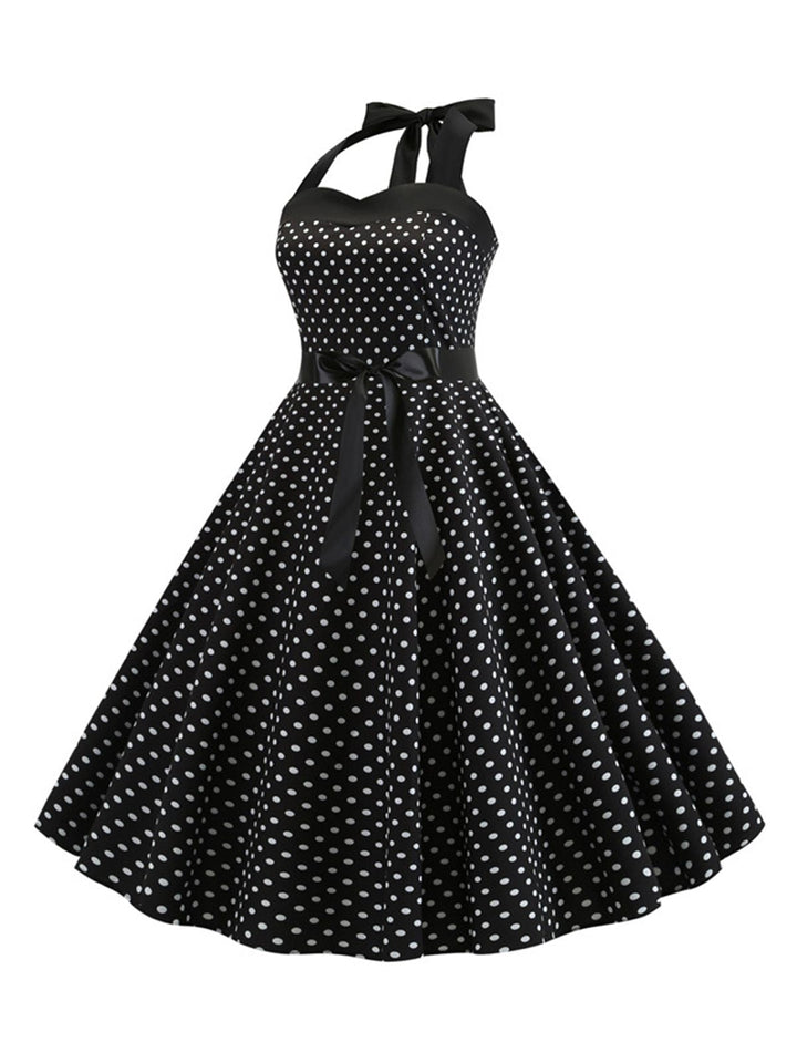 She slips into this 1950s Polka Dot Bow Tie Halter Swing Dress and suddenly it&