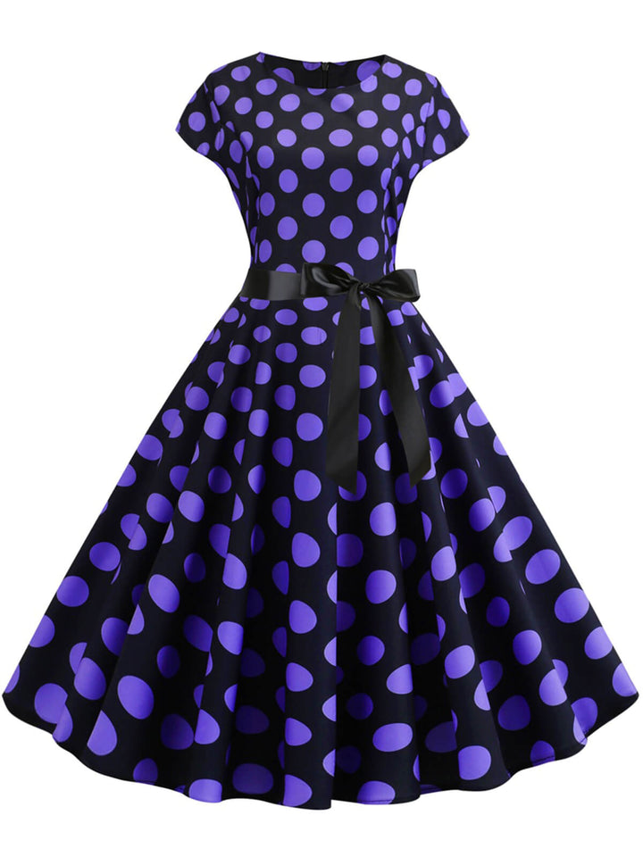 She slips into this 1950s Polka Dot Cap Sleeved Dress and suddenly it&