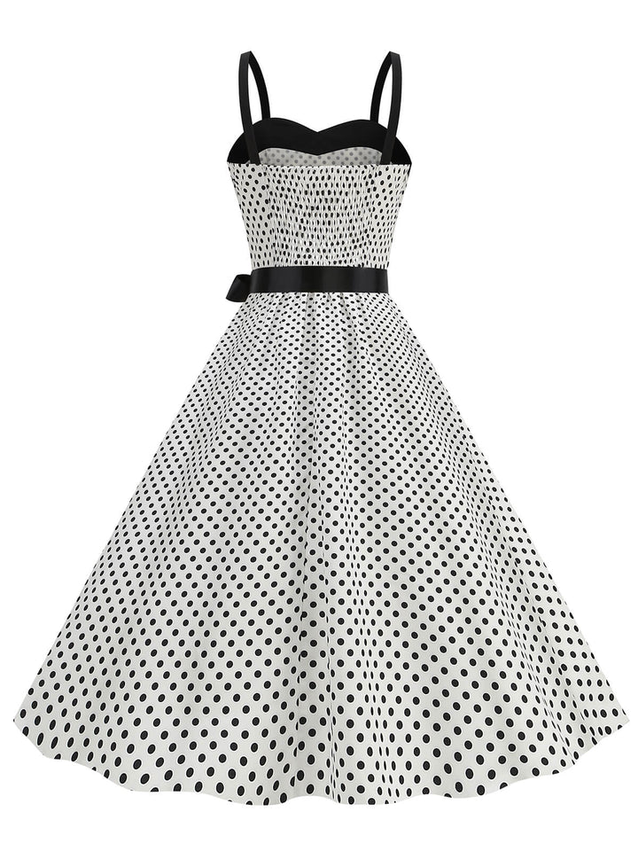 She slips into this 1950s Polka Dots Patchwork Ribbon Strap Dress and suddenly it&