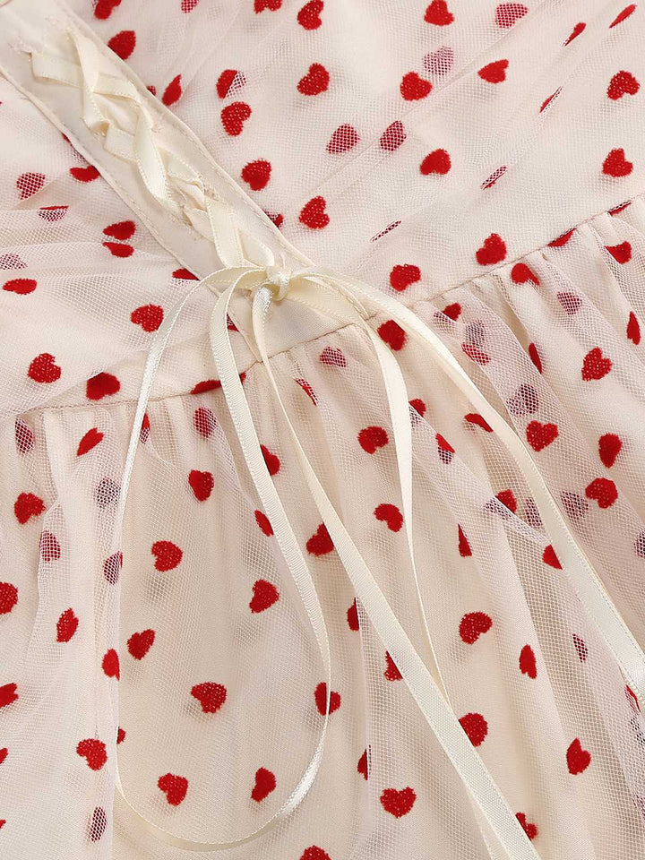 She slips into this 1950s Puff Sleeve Valentine Heart Mesh Dress and suddenly it&