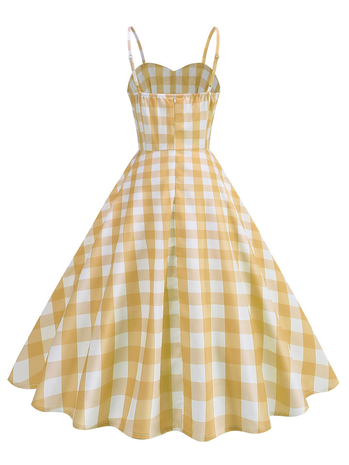 She slips into this 1950s Ruched Spaghetti Straps Gingham Plaid Dress and suddenly it&
