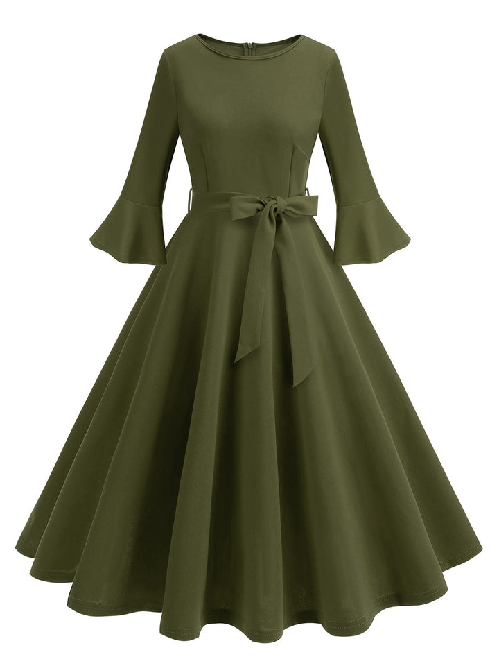 She slips into this 1950s Solid Bell Sleeves Swing Dress and suddenly it&