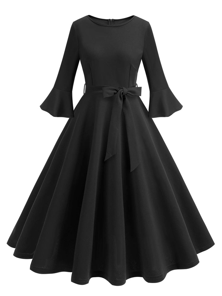 She slips into this 1950s Solid Bell Sleeves Swing Dress and suddenly it&