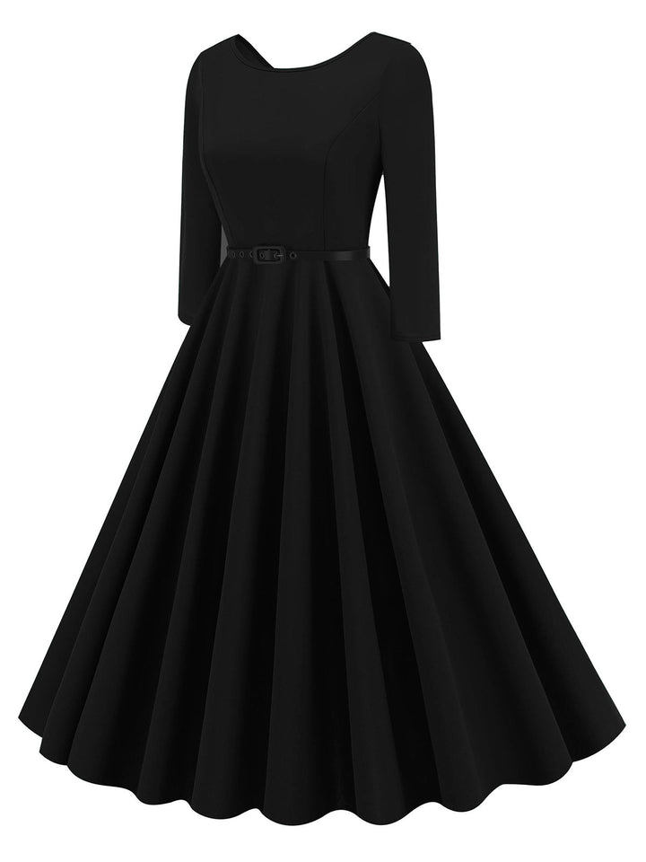 She slips into this 1950s Solid Belted Swing Dress and suddenly it&