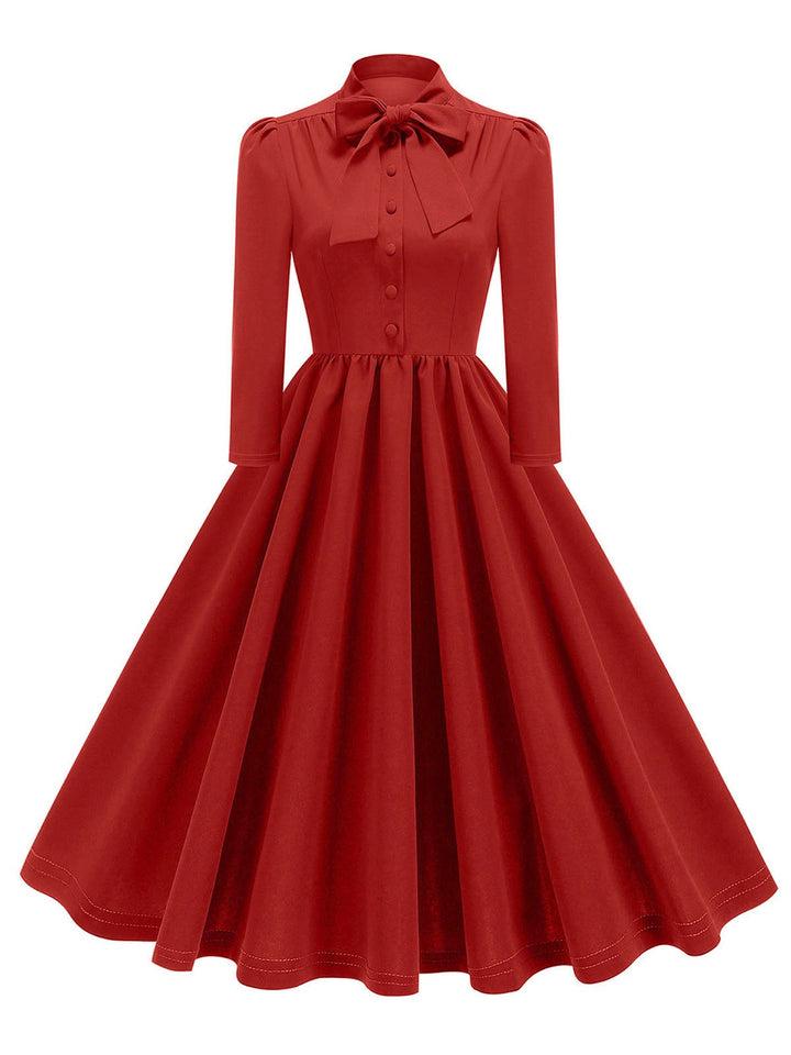 She slips into this 1950s Solid Bow Collar Buttoned Swing Dress and suddenly it&
