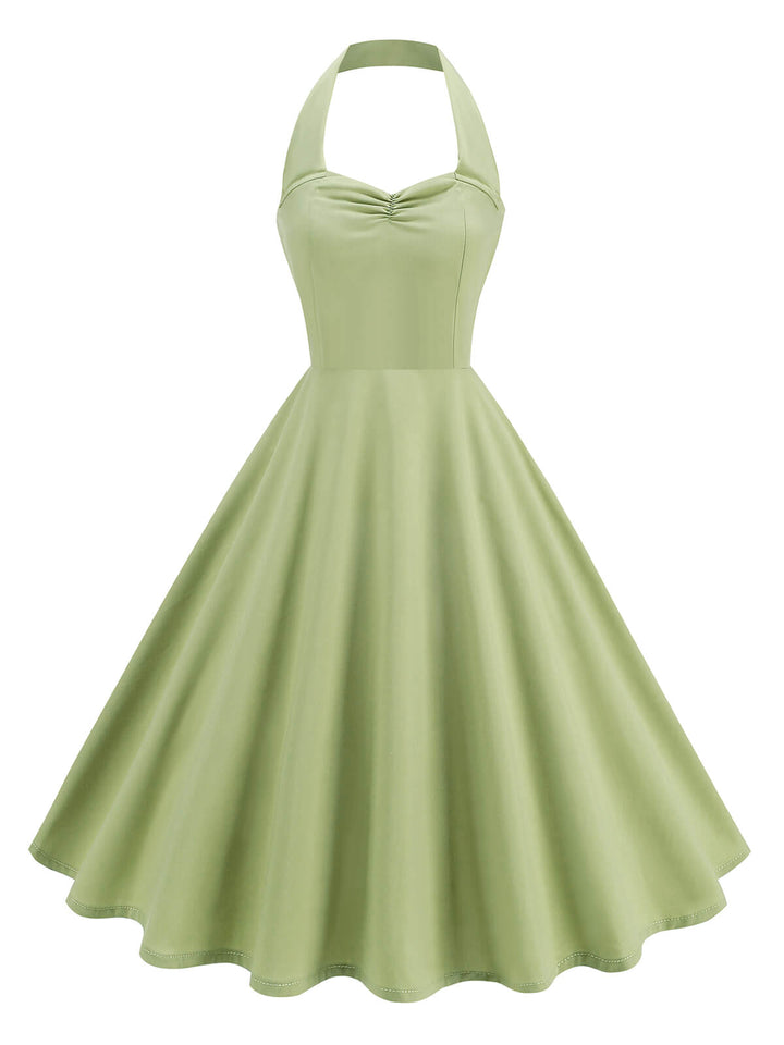 She slips into this 1950s Solid Sweetheart Neck Halter Dress and suddenly it&