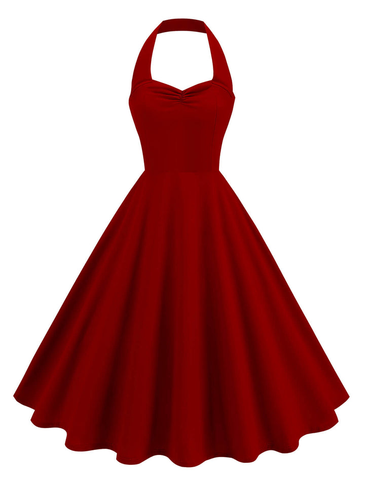 She slips into this 1950s Solid Sweetheart Neck Halter Dress and suddenly it&