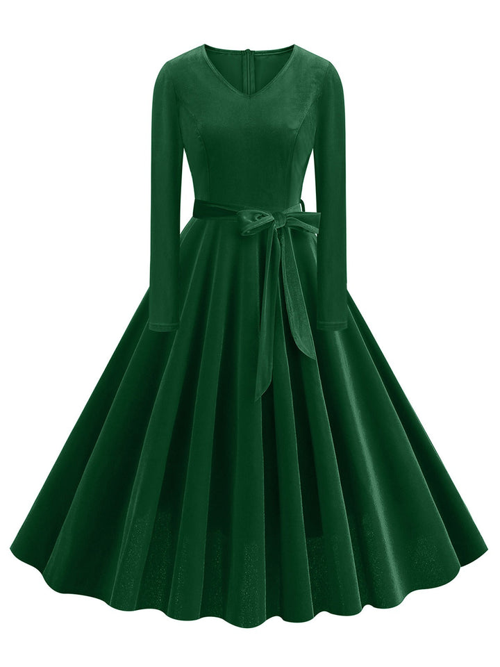 She slips into this 1950s Solid Velvet V-Neck Swing Dress and suddenly it&
