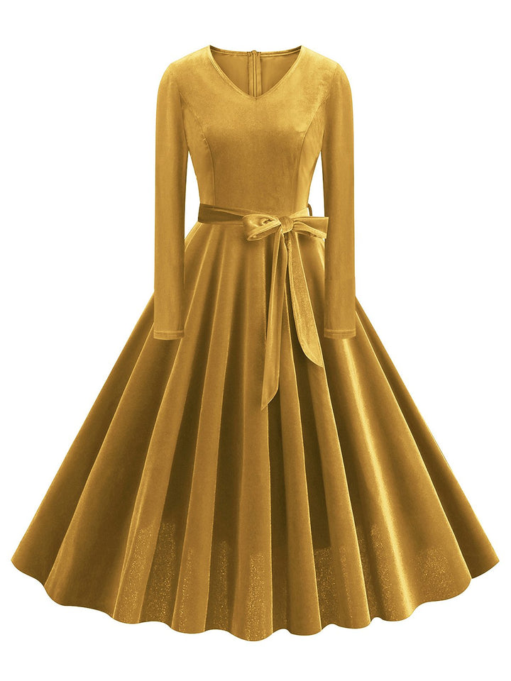 She slips into this 1950s Solid Velvet V-Neck Swing Dress and suddenly it&