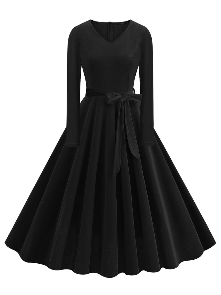 She slips into this 1950s Solid Velvet V-Neck Swing Dress and suddenly it&