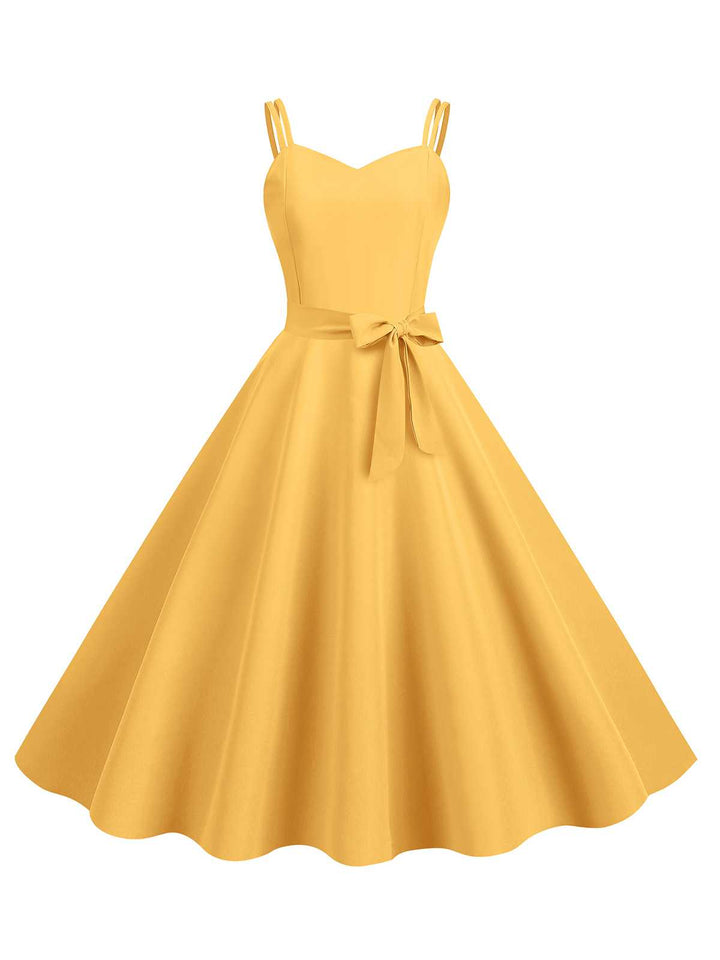 This 1950s Spaghetti Strap Bow Decor Solid Dress wraps her in 1950s elegance, one twirl at a time