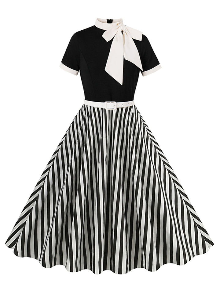 She slips into this 1950s Tie Neck Black &amp; White Stripes Belted Dress and suddenly it&