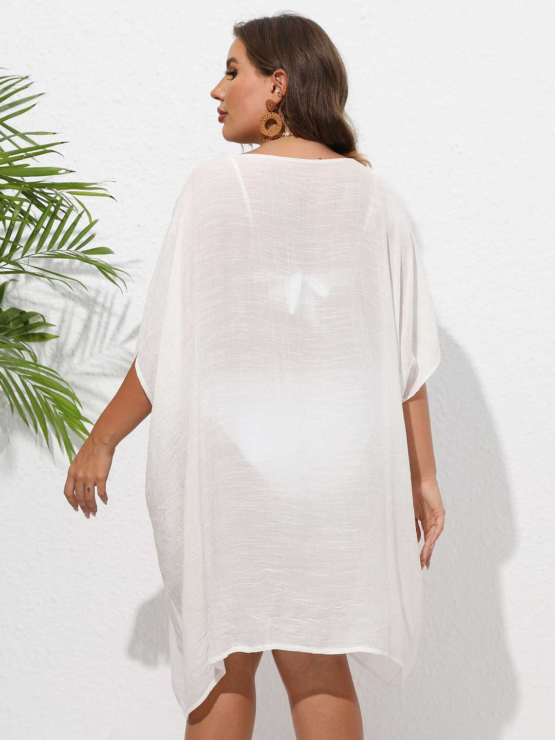 This Solid Patchwork Loose Cover-Up whispers secrets to those who notice