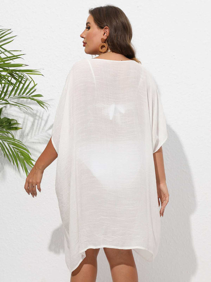 This Solid Patchwork Loose Cover-Up whispers secrets to those who notice