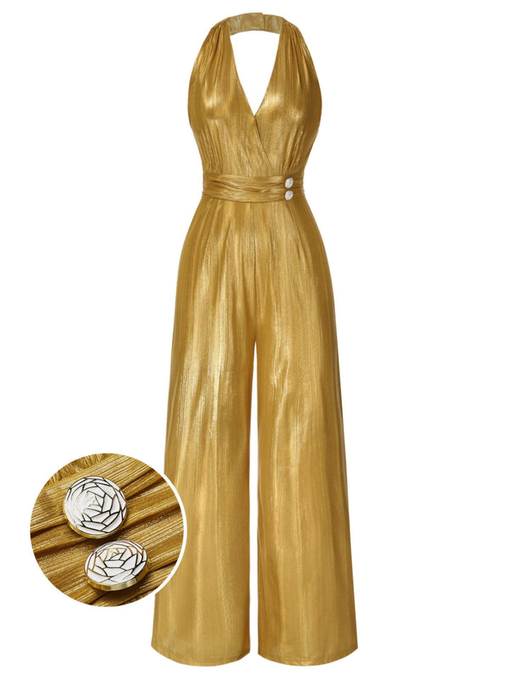 A shimmering gold 1970s style halter jumpsuit with a deep V-neck and wide-leg trousers, featuring ornate button details on the waist.