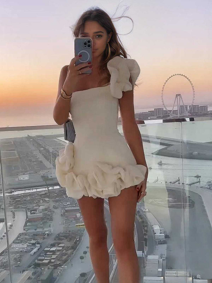 She slips into this 1980s Solid One-Shoulder 3D Flower Mini Dress and suddenly it&