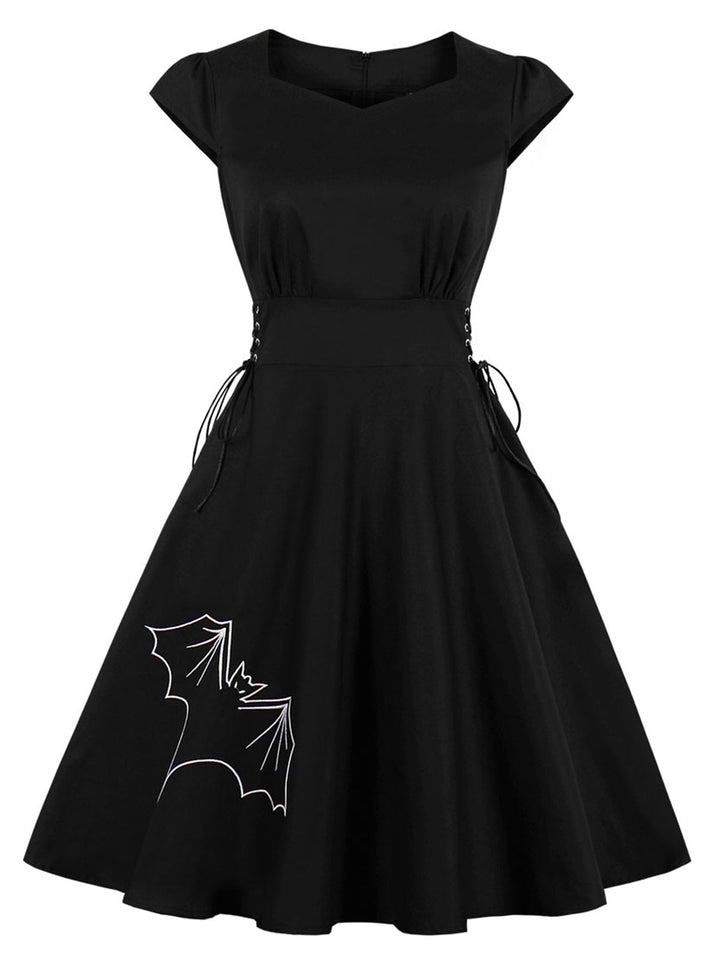 She slips into this Black 1950s Halloween Bat Lace-Up Dress and suddenly it&