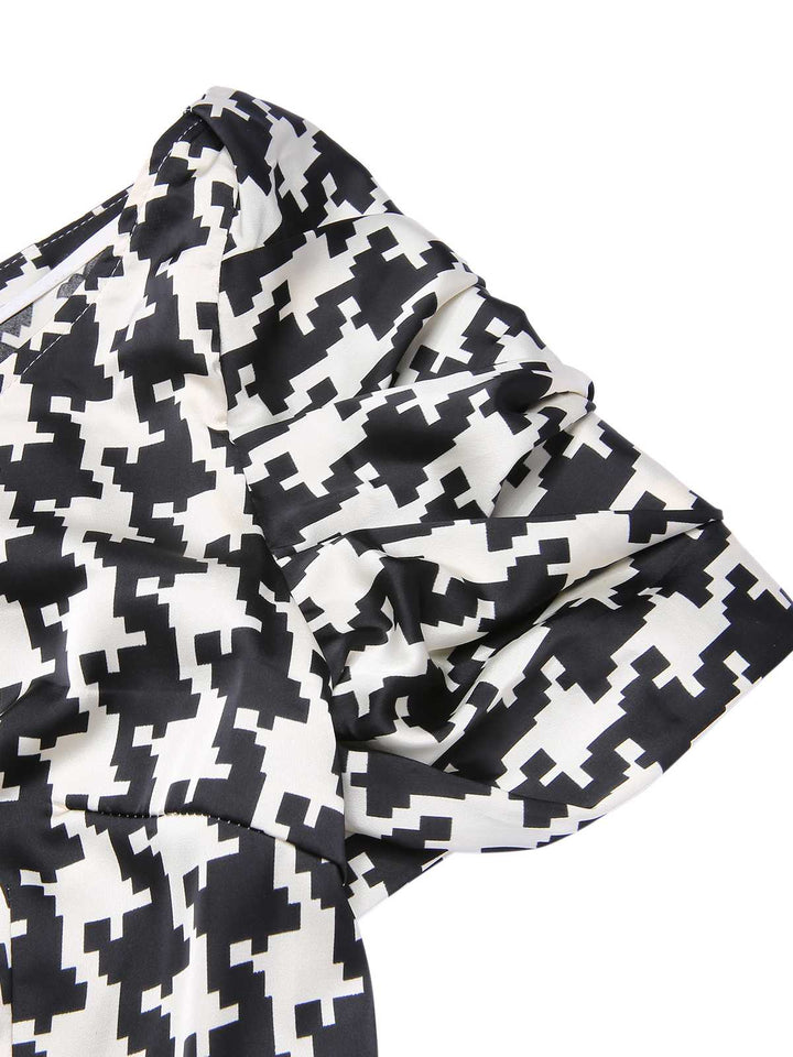 Black 1950s Houndstooth Short Sleeve Belted Dress — vintage elegance for the modern woman