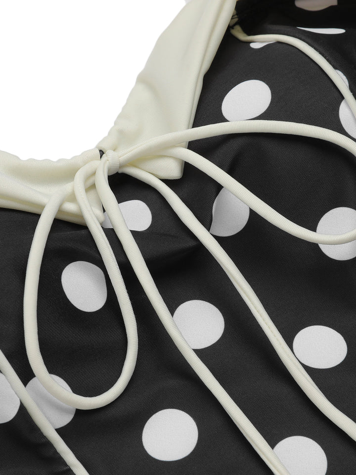 Close-up: 1950s Black 1950s Polka Dots Halter Swimsuit, perfect for vintage themed parties and retro fashion enthusiasts
