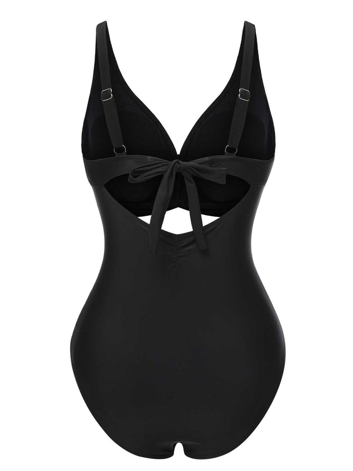 This Black 1950s Strap Hollow One-Piece Swimsuit carries 1950s vacation dreams in every stitch