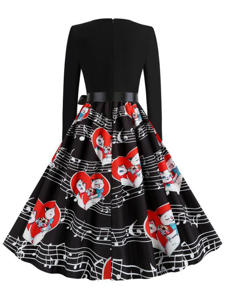 This Black 1950s Valentine Cats &amp; Music Note Patchwork Dress wraps her in 1950s elegance, one twirl at a time