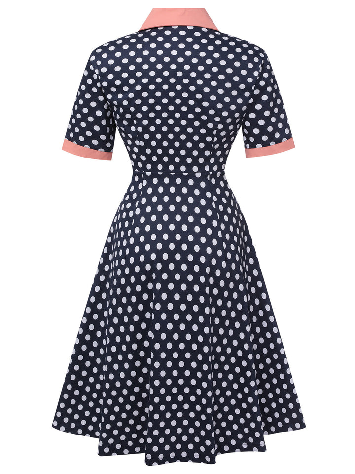 This Dark Blue 1950s Polka Dot Lapel Dress wraps her in 1950s elegance, one twirl at a time
