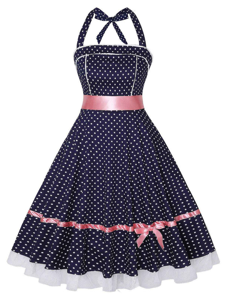 She slips into this Navy Blue 1950s Polka Dot Halter Dress and suddenly it&