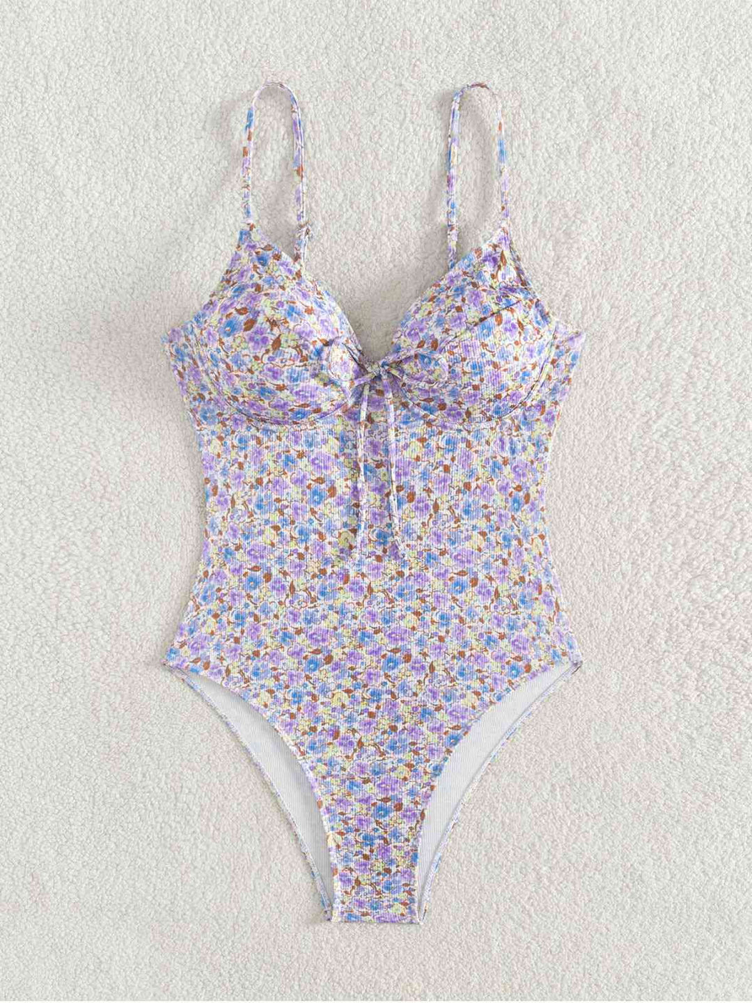 This Purple 1950s Ditsy Floral Lace-Up One-Piece Swimsuit carries 1950s vacation dreams in every stitch
