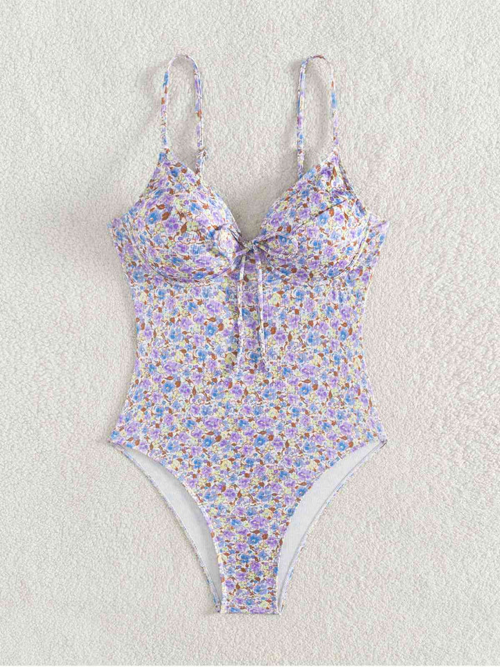 This Purple 1950s Ditsy Floral Lace-Up One-Piece Swimsuit carries 1950s vacation dreams in every stitch