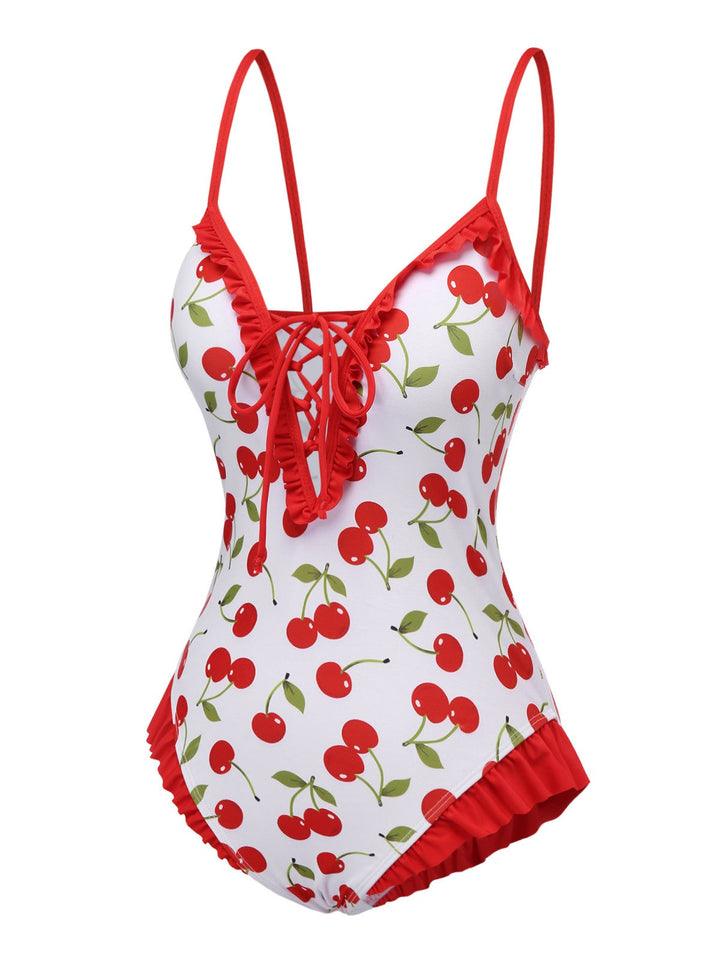 This Red Cherry Lace-Up Ruffled Swimsuit carries vacation dreams in every stitch