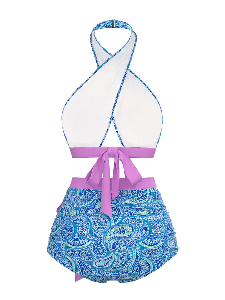 This Violet 1970s Paisley Print Cross-Halter Swimsuit carries 1970s vacation dreams in every stitch